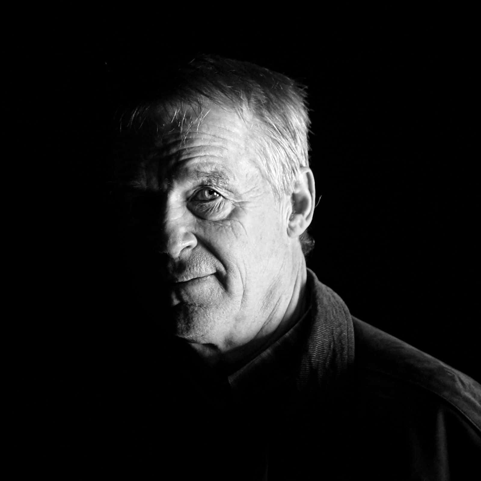 Black-and-white portrait of Swedish Colonel Ulf Henricsson standing in an abandoned field hospital in Bosnia, photographed by Johnny Gustavsson in 2003.