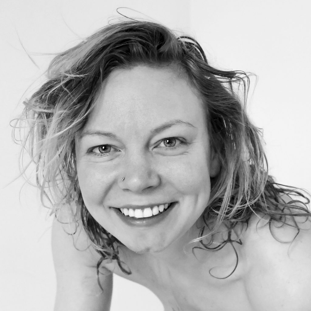 Portrait in black and white of woman with a smile and white teeth