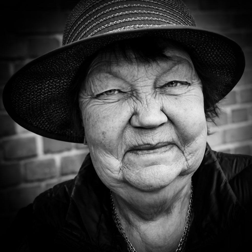 Portrait in black and white of  older woman in a hat