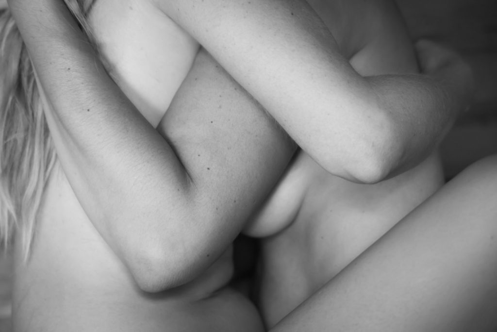 A black and white close-up photo of two women in a sauna,